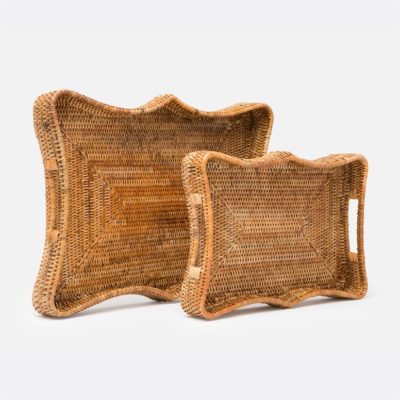 Two large woven rattan trays with a scalloped edge, one natural and one white washed, in the foreground against a neutral background.