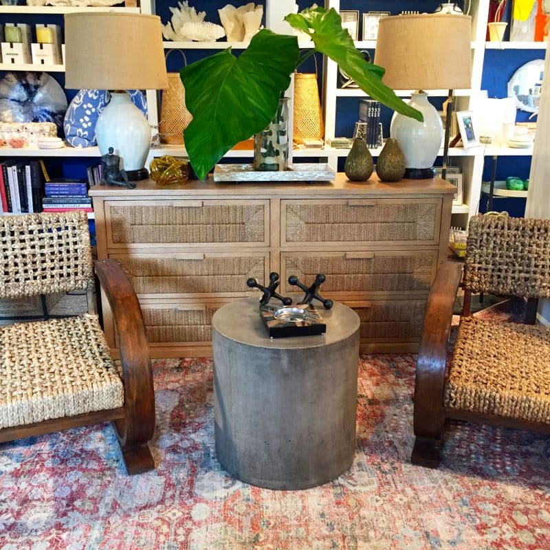 A light brown Malibu Rope and Wood 6 Drawer Dresser with Hardwood Handles set against a backdrop of wicker furniture and potted