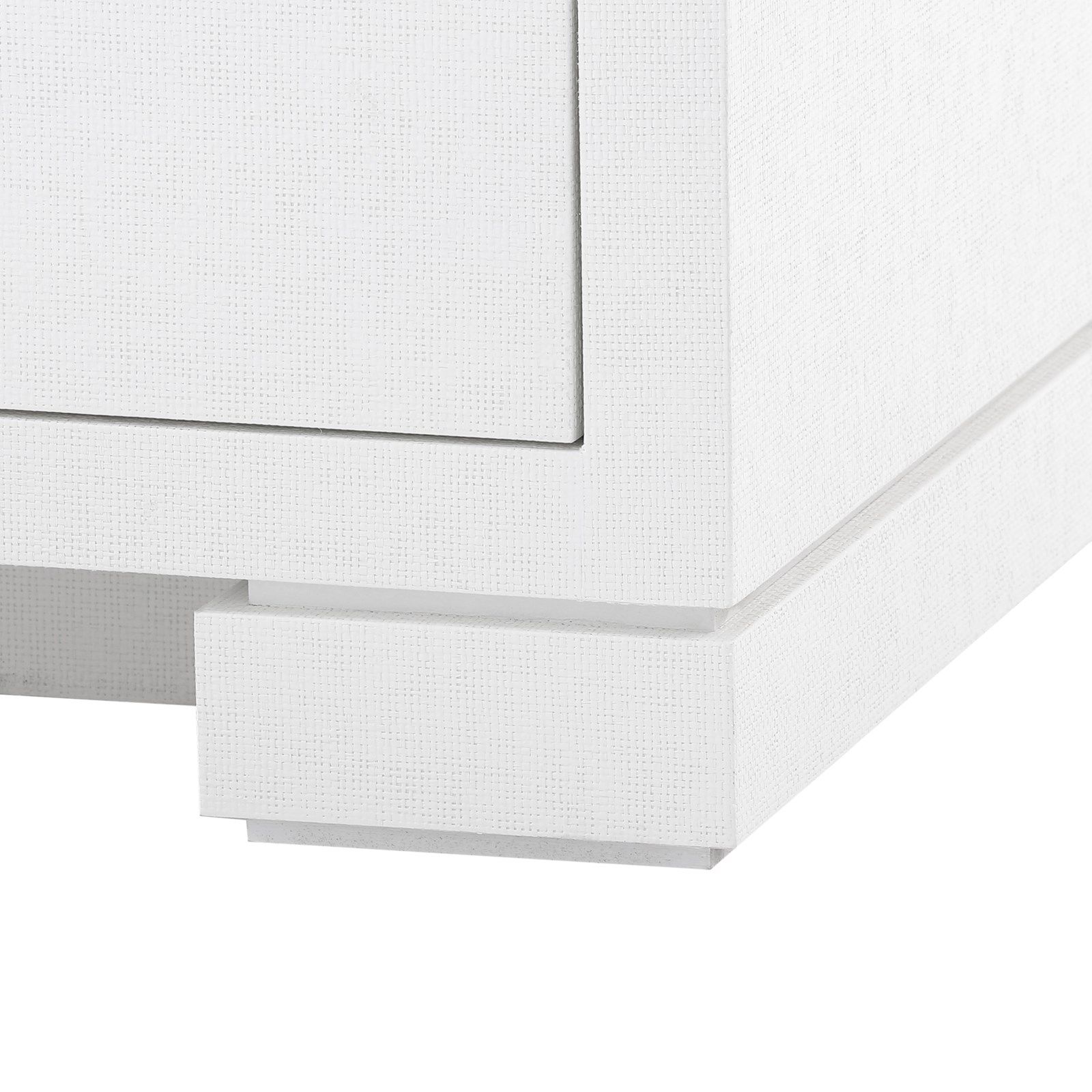 Close-up of white lacquered Freeport six drawer dresser with chrome handles and grasscloth texture.
