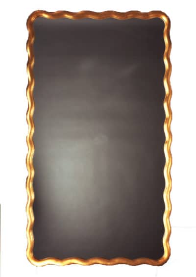Large scalloped mirror with antique gold leaf art nouveau design, featuring undulating moulding.