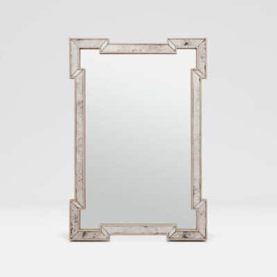 Antiqued mirror panel in ornate frame, reflecting elegance and sophistication.