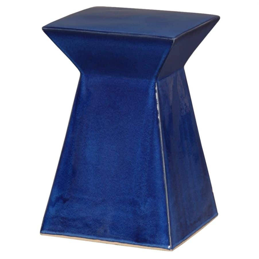 A vibrant blue ceramic garden stool, handcrafted with unique textures and glaze pitting, set against a contrasting white background.