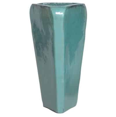 A large, blue ceramic pot with a triangular shape and a glossy finish.