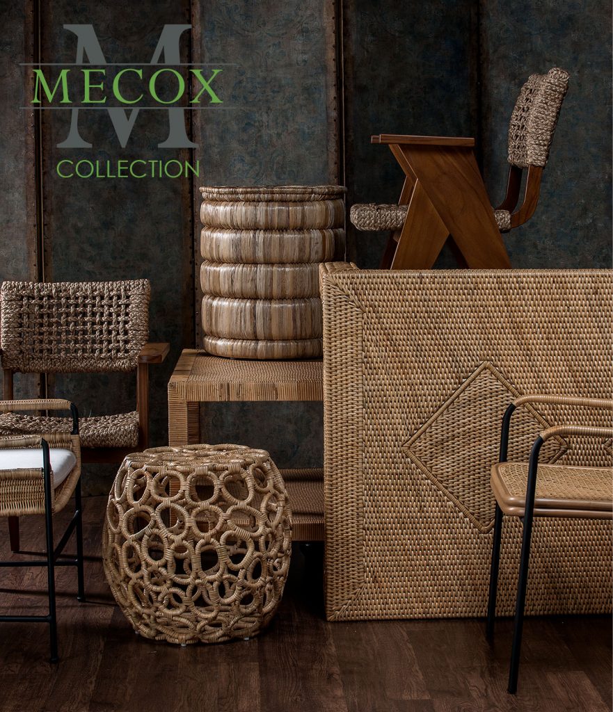 A collection of wicker furniture displayed in a room with various pieces including chairs tables and a bench arranged against a dark