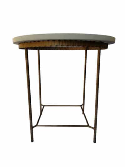 A round side table with a marble top and a metal base, featuring a linenfold design on the legs.