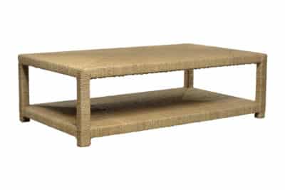 A rectangular coffee table with a natural finish and a mahogany wood frame, placed in an indoor setting.