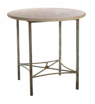 Round metal side table with a cross stretcher design and a light travertine top, presented in a close-up view.