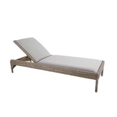 Wicker chaise lounge with cushioned seat and backrest, featuring a woven design and covered in a fabric that resembles leather.