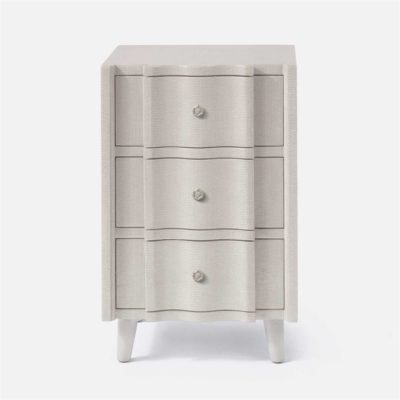 A small, light beige nightstand with three drawers and a knob on each drawer.