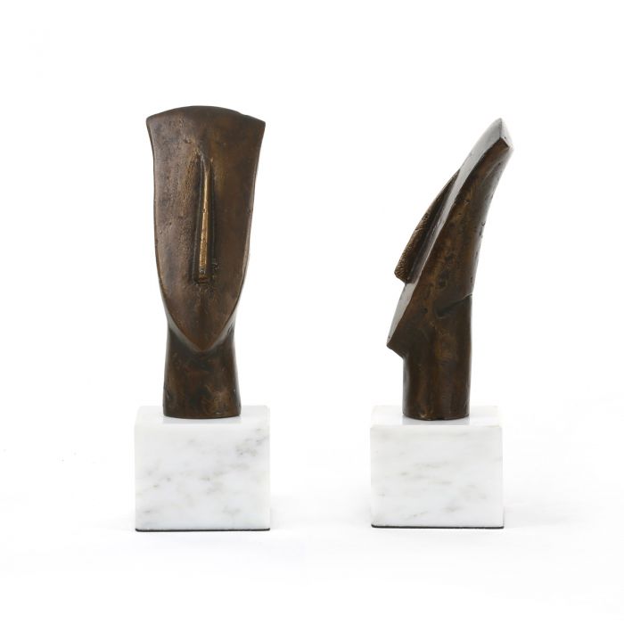 Two bronze statues of lost heads on a white marble base each with one hand raised to its head presented in a
