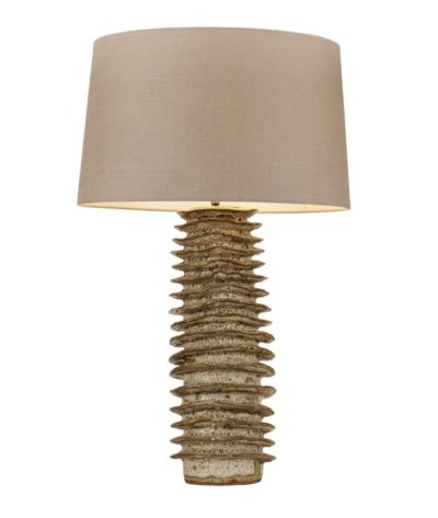 Tubular glazed ceramic lamp with a beige shade and gold base featuring a unique design element that resembles a stack of books