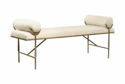 Metal bench with cushioned backrest and armrests featuring a traditional design with vertical slats and a curved top rail upholstered in a