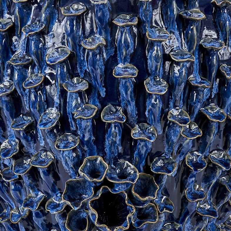 The image showcases a large faux coral blue and white ceramic vase with each one exhibiting unique size and shape variations This