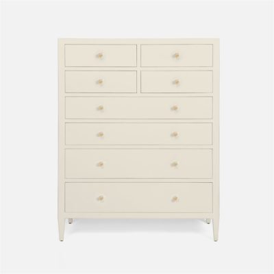 A tall, light-colored dresser with multiple drawers and a minimalist design.