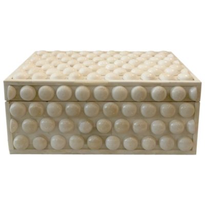 Cream button box with hinged top, featuring a collection of round, embossed buttons on its side.