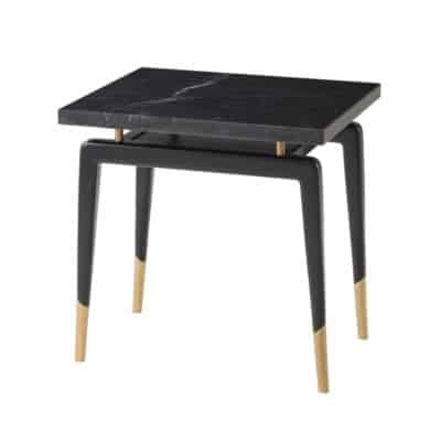 Black marble side table with a sleek modern design featuring brass accents and a black veined marble top set against a white