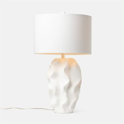The image displays a modern minimalist table lamp with a unique design It is predominantly white in color featuring an abstract sculptural