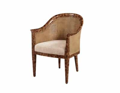 Tortoiseshell finished chair with cane back and oatmeal upholstered seat.