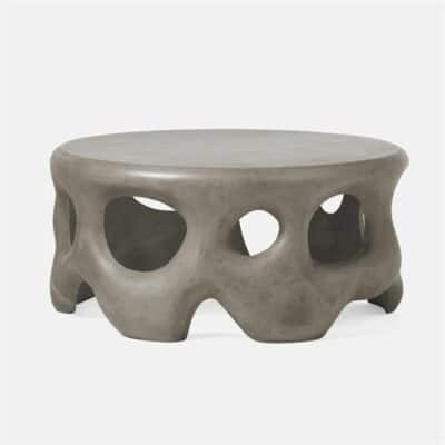 Round outdoor coffee table with sculpted concrete base.
