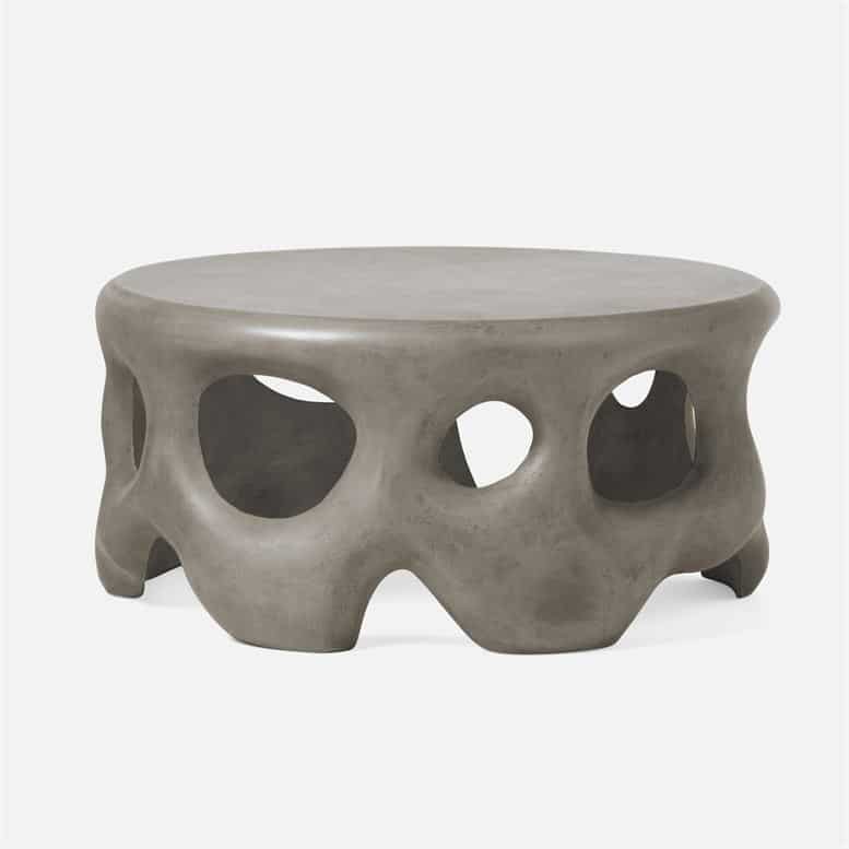 Round outdoor coffee table with sculpted concrete base.