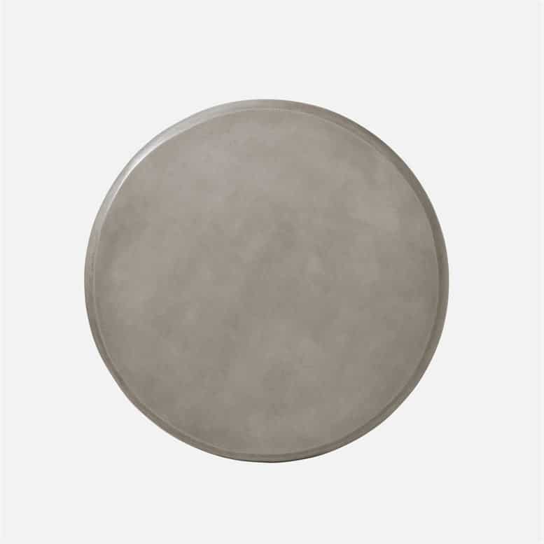 Outdoor sculpted concrete coffee table, smooth grey finish, handmade texture.
