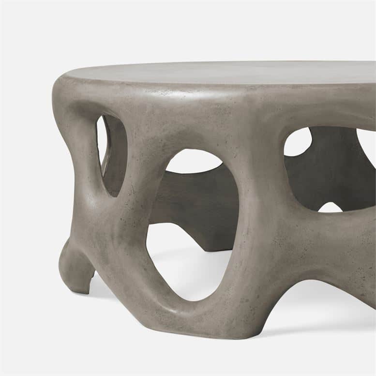 Outdoor sculpted concrete coffee table in grey.