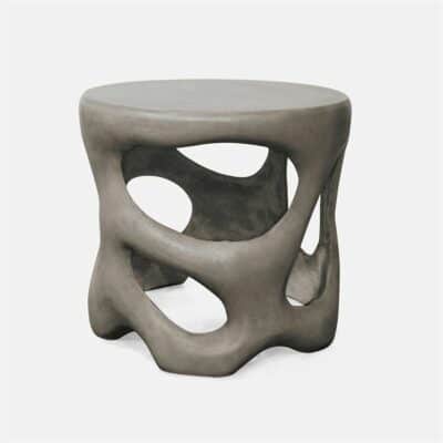Handmade smooth grey reinforced concrete outdoor side table with sculpted design.