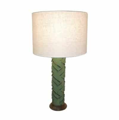 Antique wallpaper block cylinder lamp on display.