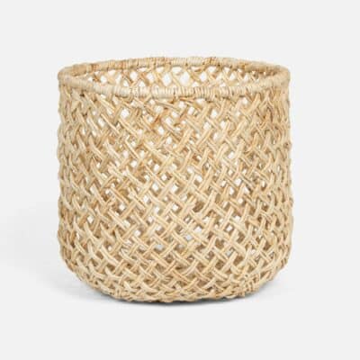 Large round woven basket with bleached banana bark material and open weave design.