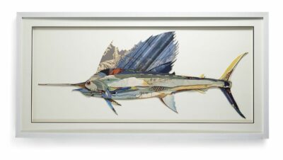 A framed artwork depicting a stylized swordfish with vibrant colors, created from collage materials on a shadowbox background.