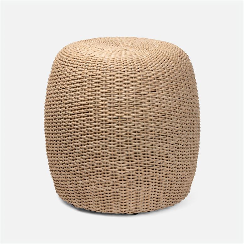 A woven stool with a natural-toned twisting rope texture, placed outdoors under a clear sky.