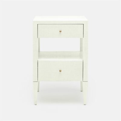 A white low small Hilton faux raffia bedside table, with a bottom shelf and two drawers on top, against a plain background.