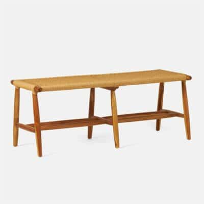 Vintage-style teak bench with woven seat, showcasing warm wood tones and natural fiber texture.