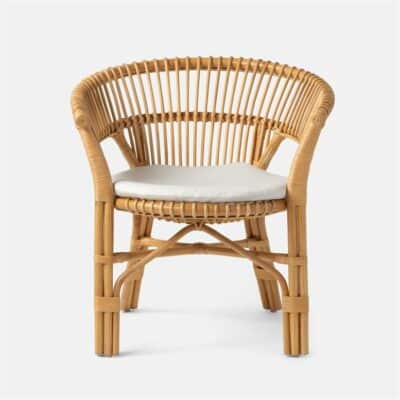 Bamboo frame woven rattan dining chair with double rail back and flared arm, round seat cushion.