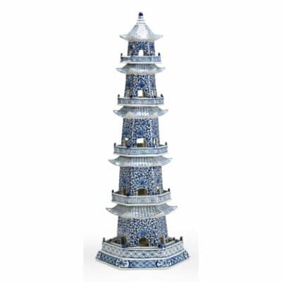 White and cobalt ceramic pagoda, hand-painted with intricate details, showcasing a traditional Chinese design, standing tall against a plain background.