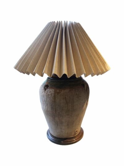 Large decorative lamp with raffia shade and wooden base.