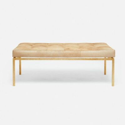 Tufted cowhide ottoman in beige leather with metal frame.