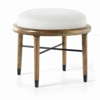Round ottoman with natural oak finish, white boucle upholstery, and black metal legs and hardware.