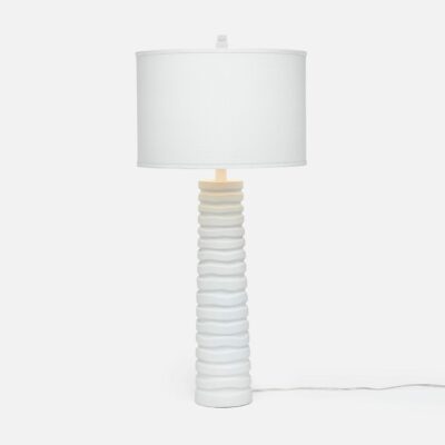 White table lamp with wavy lines design, featuring a cylindrical shade and a minimalist aesthetic.
