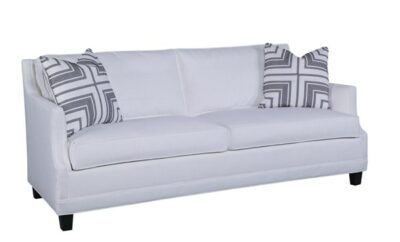 White, upholstered Chelsea sofa in parchment fabric, featuring French Spring Roast finish and plush down fill.