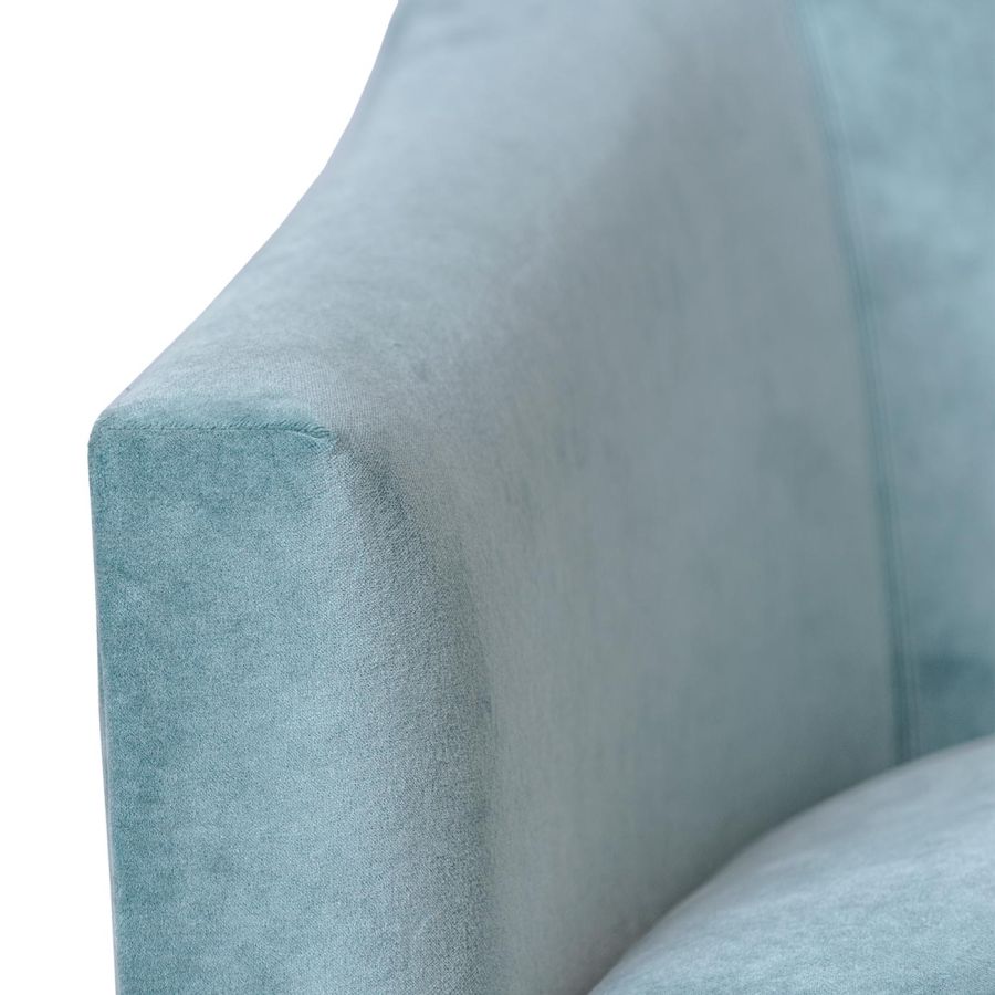 Elegant blue velvet swivel chair, upholstered in ocean poly velvet with spring down seat cushion and tobacco finished base.