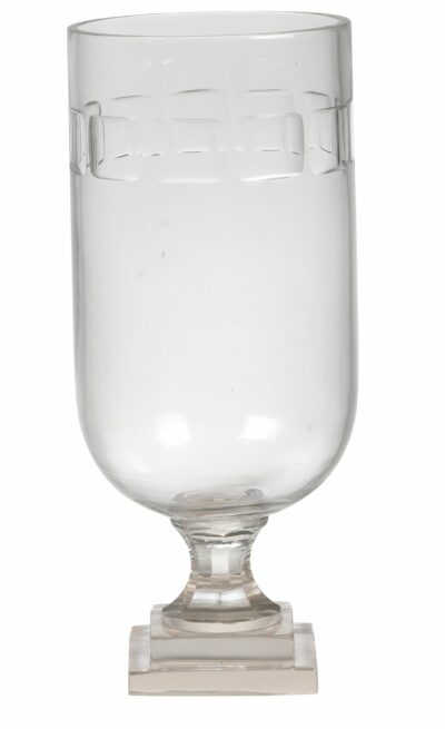 Handcrafted glass hurricane with a one-lined thumb design, showcasing its mouth blown glass facets against a white background.