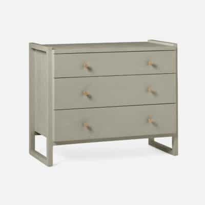 Small, modern dresser with three drawers, featuring a sleek design in castor gray or French gray finish, available in other styles.