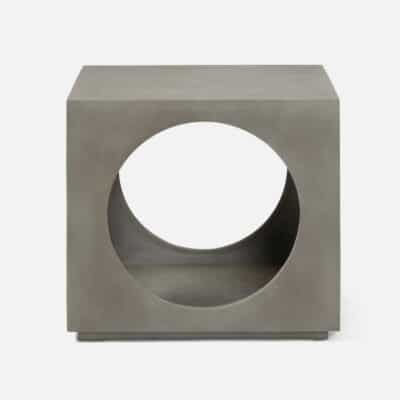Gray concrete cube outdoor side table with circular cutouts.