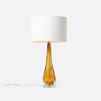 Elegant modern table lamp with a clear acrylic base and a frosted glass shade, available in amber or sapphire.