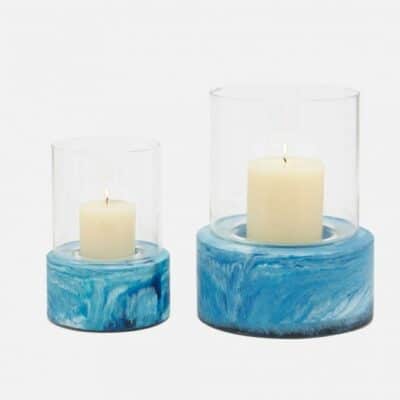 Two marbled resin hurricanes, one large and one small, showcasing their unique blue swirl patterns against a white background.
