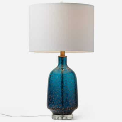 Aqua blue glass lamp with gold flecks, showcasing elegant design and craftsmanship.