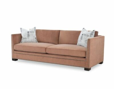 Close-up front view of Alston Sofa in plush guava fabric with brownstone legs, featuring down seat cushions and feather pillows.