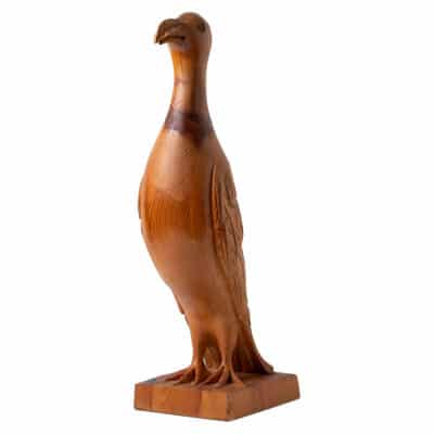 Vintage mid-century bird sculpture in walnut finish, showcasing intricate carving details and craftsmanship.