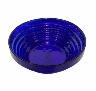 Blue glass bowl with stair step design, vintage circa 1950s, close-up image showcasing its intricate details.